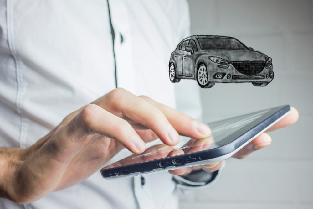 Shutterstock_685163056 image of car over cell phone in hands