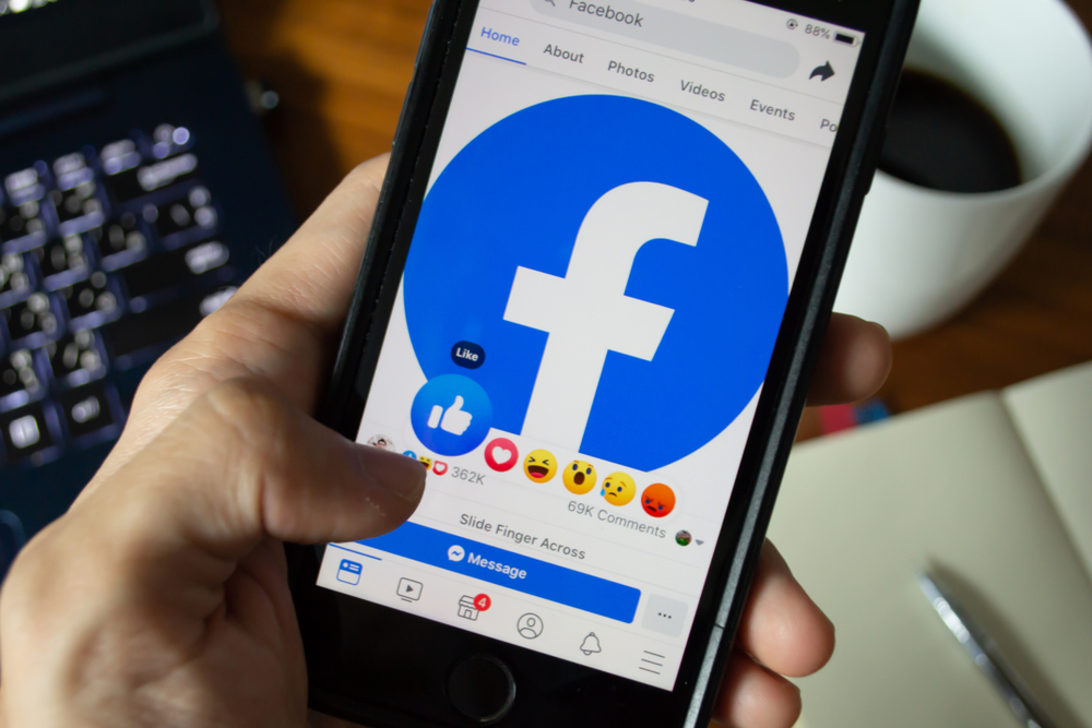 Shutterstock_1419730751 Bangkok, Thailand - June 9, 2019 : Facebook user touch on Like button in Facebook application on iPhone 7.