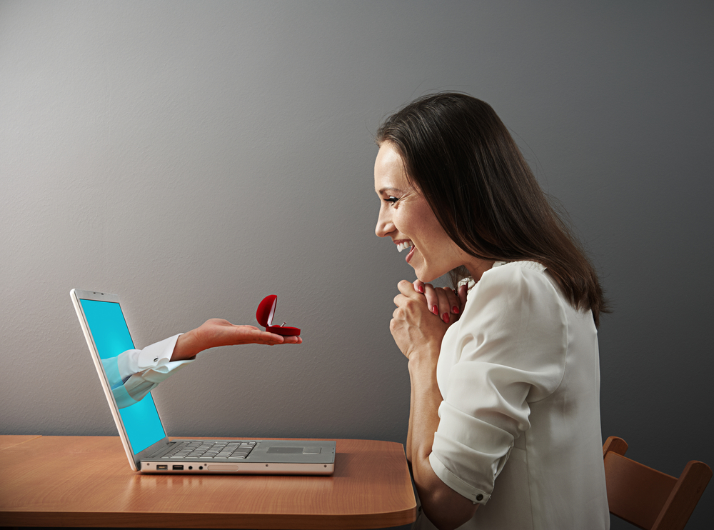 shutterstock_143970877 happy woman looking at ring