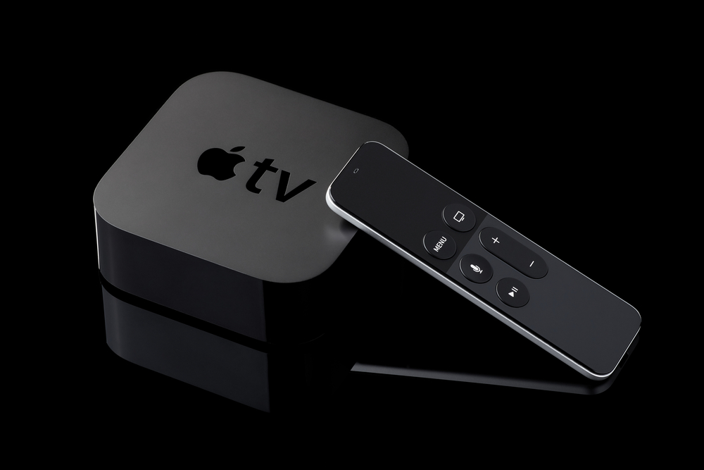 Shutterstock_471991831  Berlin, Germany - August 21, 2016: Product shot of a fourth generation Apple TV and remote on black background.