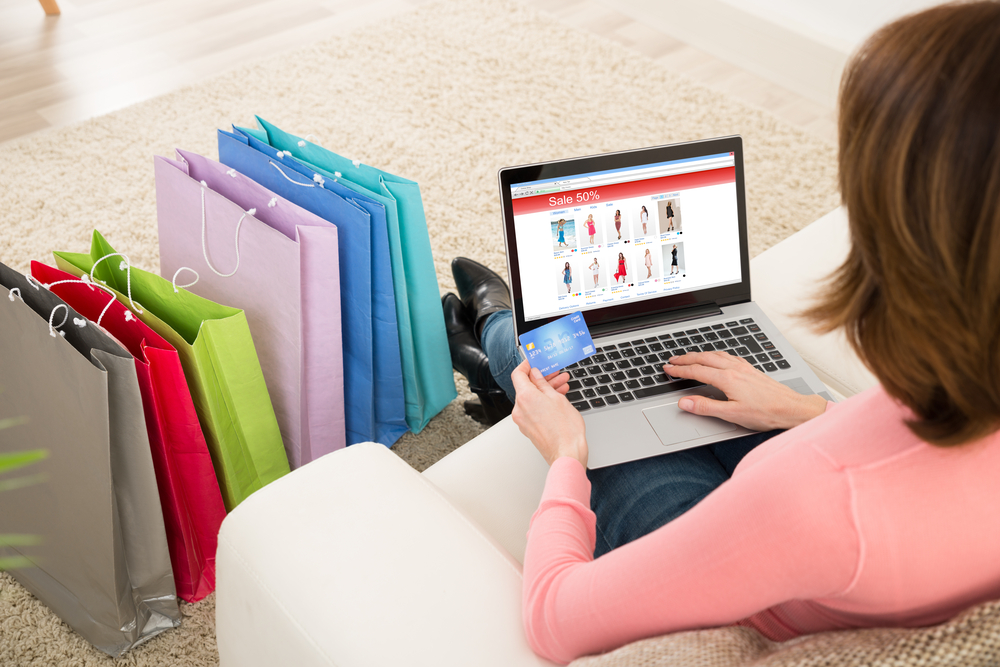 Shutterstock_389433475  Young Woman On Sofa Shopping Online With Debit Card