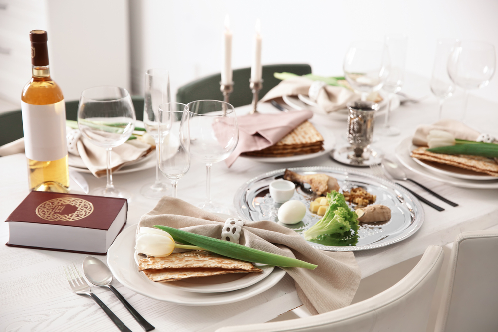 Shutterstock-1328002358 Festive Passover table setting with Torah. Pesach celebration