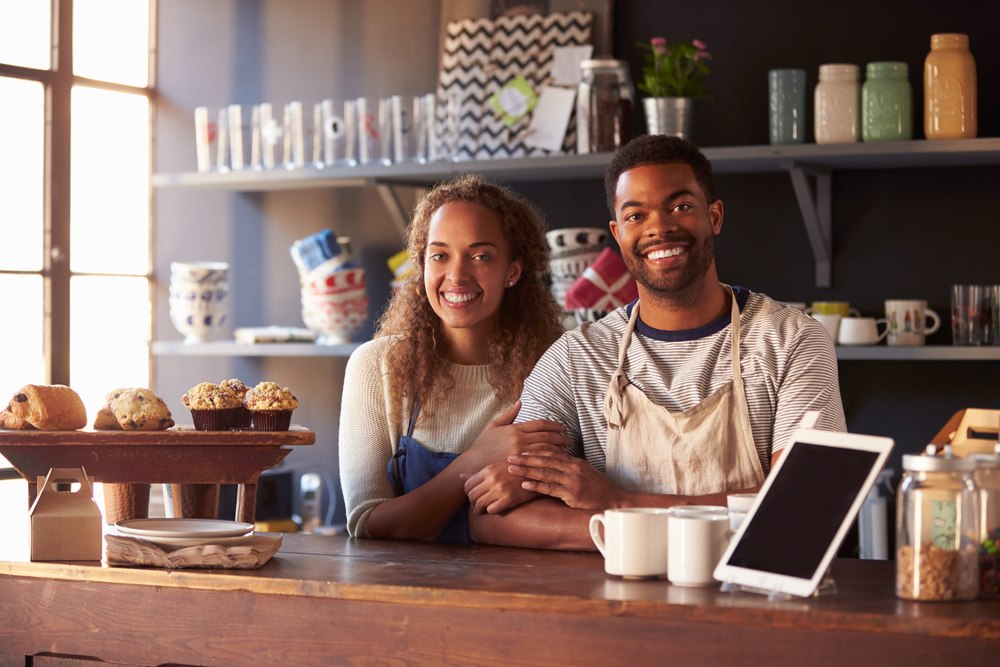 Shutterstock_372379228 Portrait Of Couple Running Coffee Shop Behind Counter