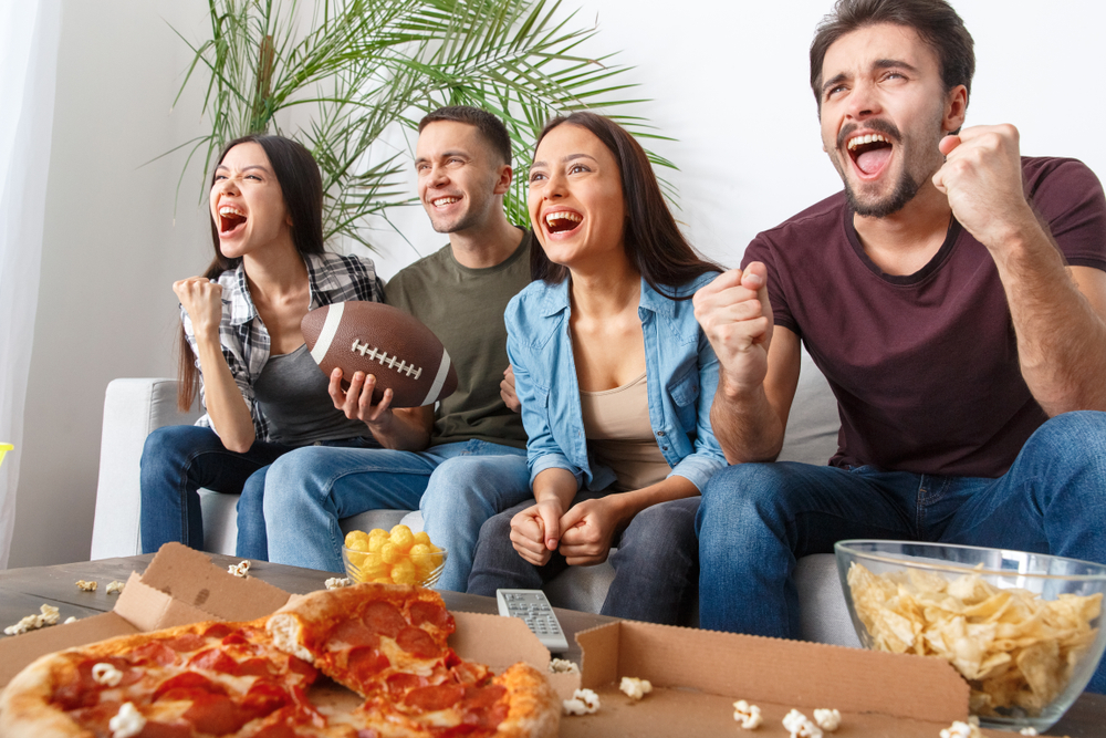 Shutterstock_1021838398 Group of friends sport fans watching rugby match victory