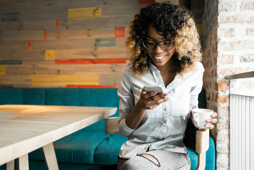 Shutterstock_606913400 african american woman using phone