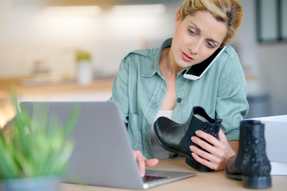 Shutterstock_579102145 Woman on the phone with customer service department